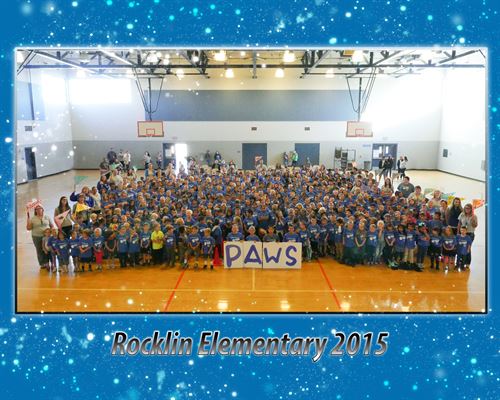 Large crowd of students holding signs spelling "PAWS", Rocklin elementary 2015